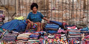 Lady selling textiles in Antigua Guatemala Contours Travel