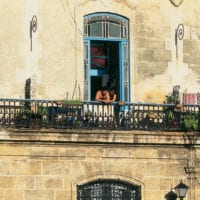 Lovers in a window travel to Cuba Havana Contours Travel