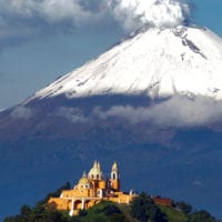 View of church and Popocatepetl Volcano in Puebla Mexico