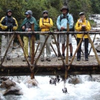 Peru Mountain Lodges Salkantay people on bridge on the way to Lucma Lodge Contours Travel
